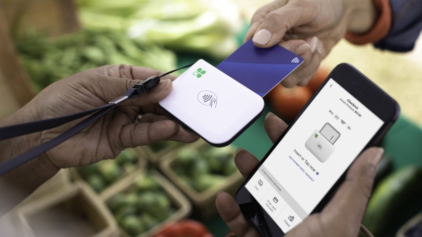 Customer paying at a food truck with a Clover mobile card reader